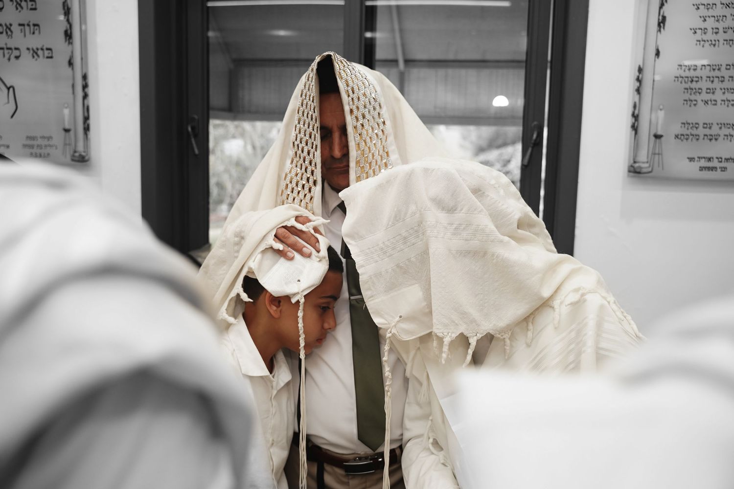 White ceremonial religious garments and accessories displayed against a light background.