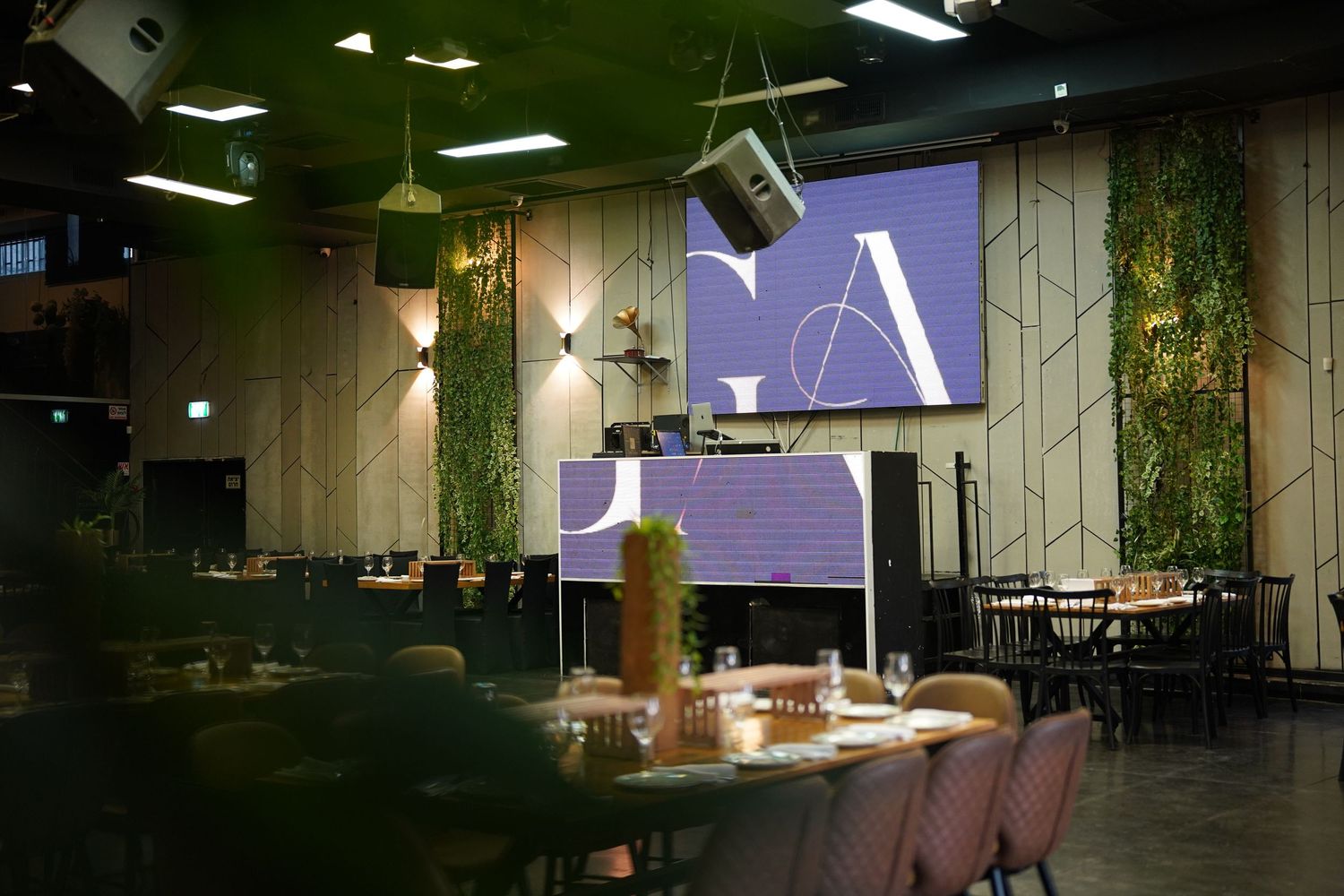 Modern restaurant interior with minimalist design and overhead lighting.