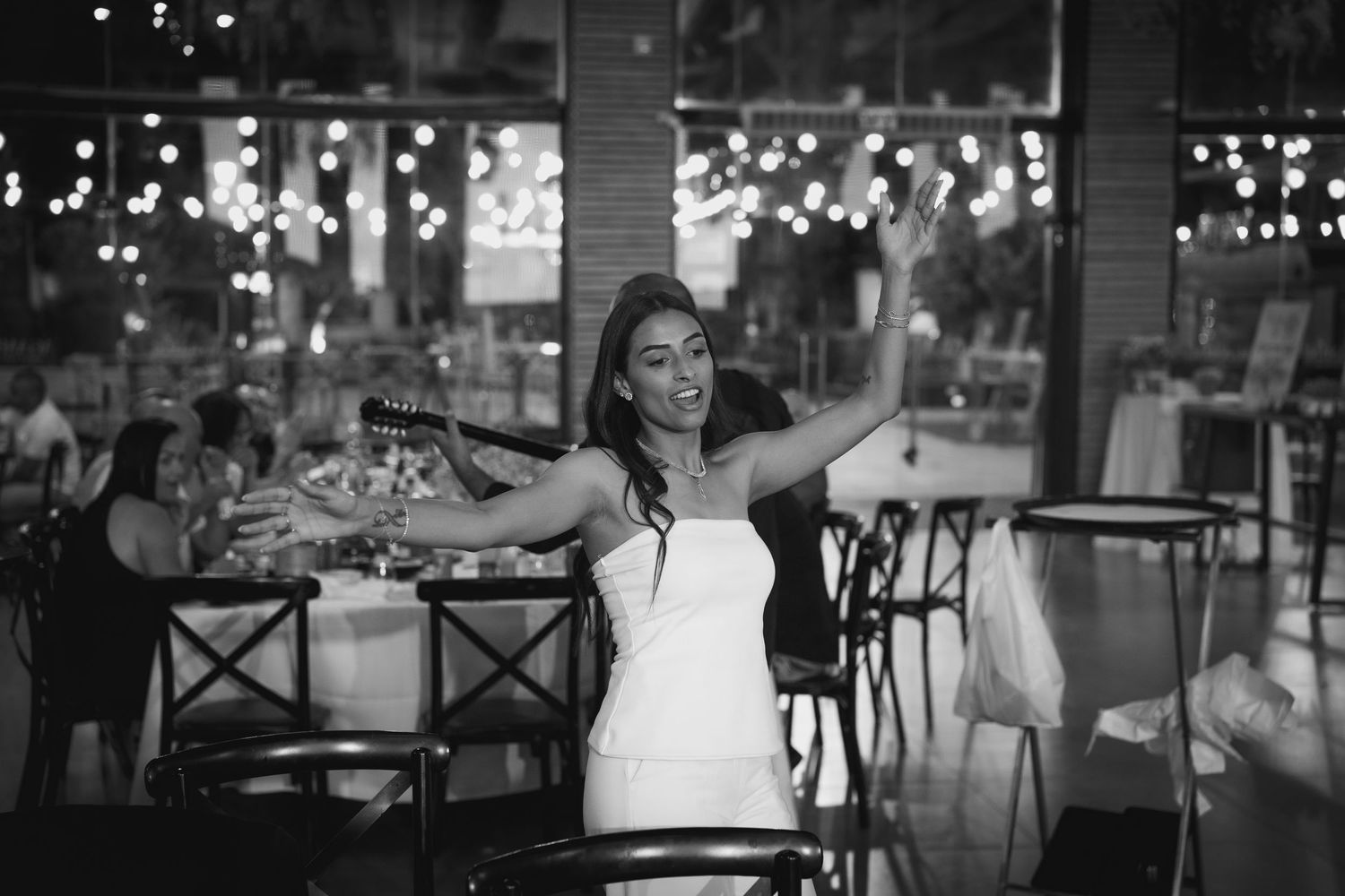 Dimly lit event space with string lights creating a romantic atmosphere.