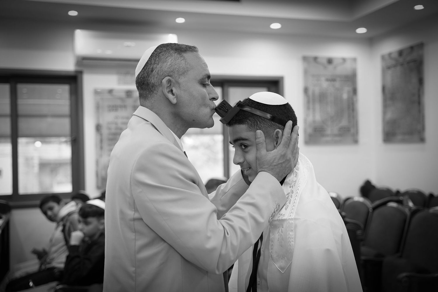 Black and white photo of people gathered in an indoor religious ceremony.