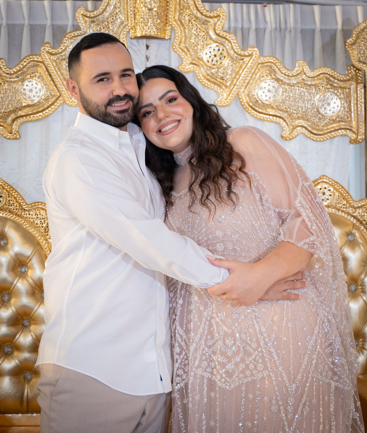 Couple in formal attire shares intimate poses against elegant gold backdrop.