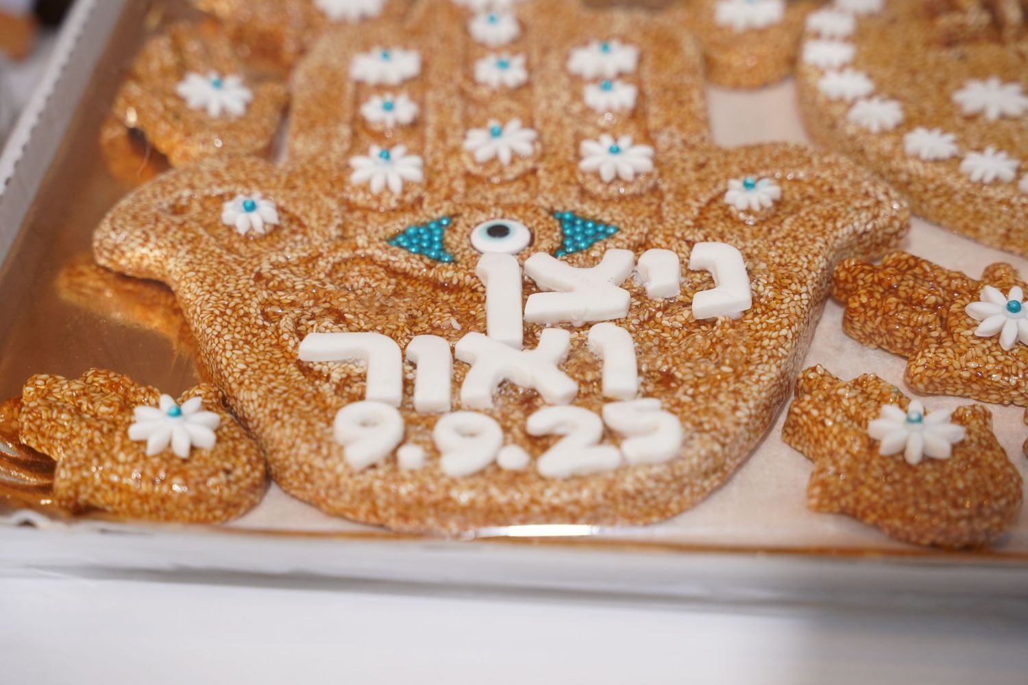 Close-up of delicate gold and white floral lace details with sparkly accents.