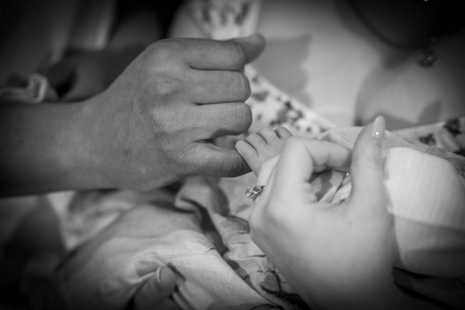 Black and white artistic close-up shots of hands and tender moments.