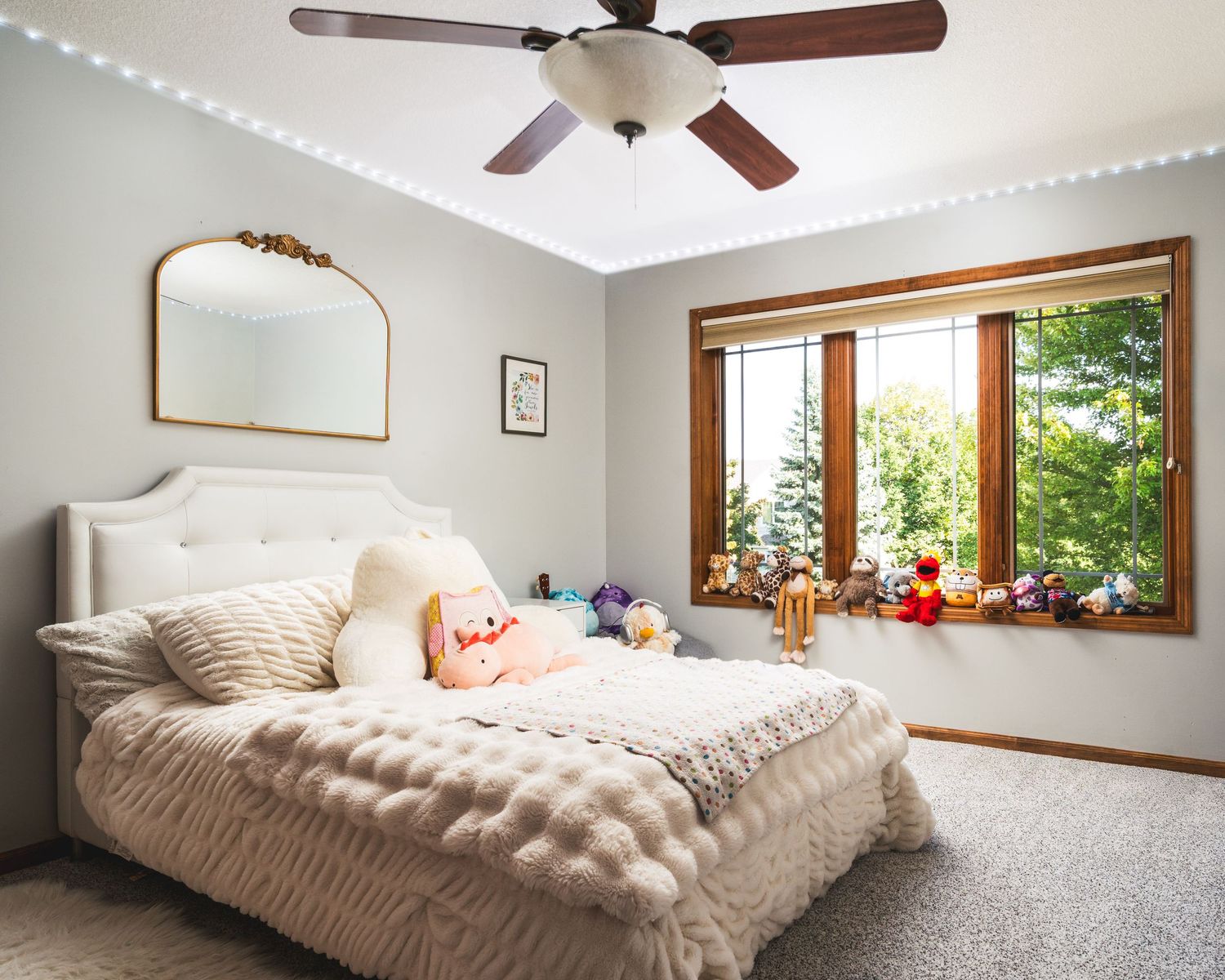 Bedroom interior with ceiling fan and large window showing progression of furniture placement from empty to fully furnished.