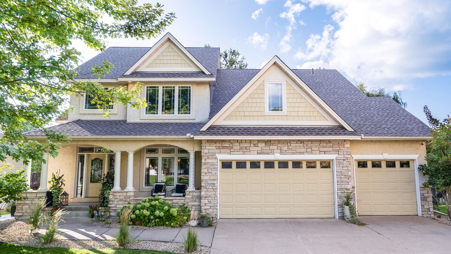 Exterior views of a modern beige and white craftsman style home with multiple angles showing architectural details and landscaping.
