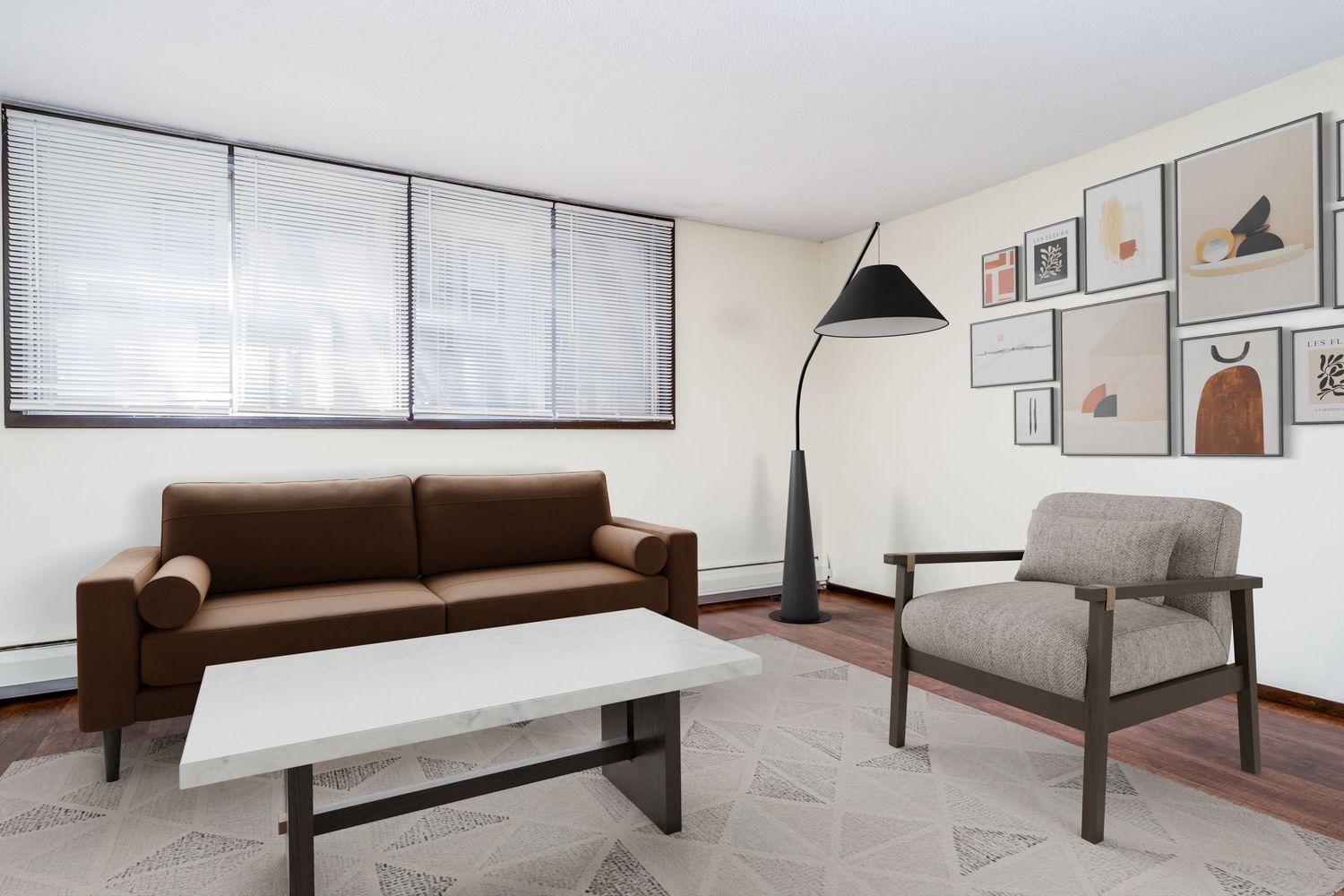 Modern bedroom interior design with white walls, wooden floors, and minimalist black and brown furniture.