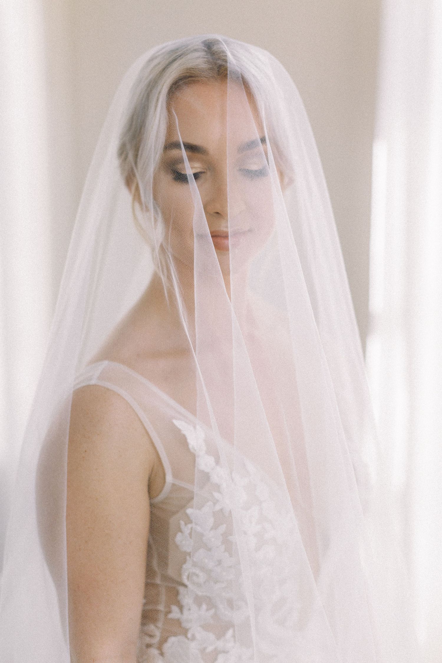 An ethereal bridal portrait with delicate veil and lace dress details captured in soft natural light Nashville, TN Wedding Photographer