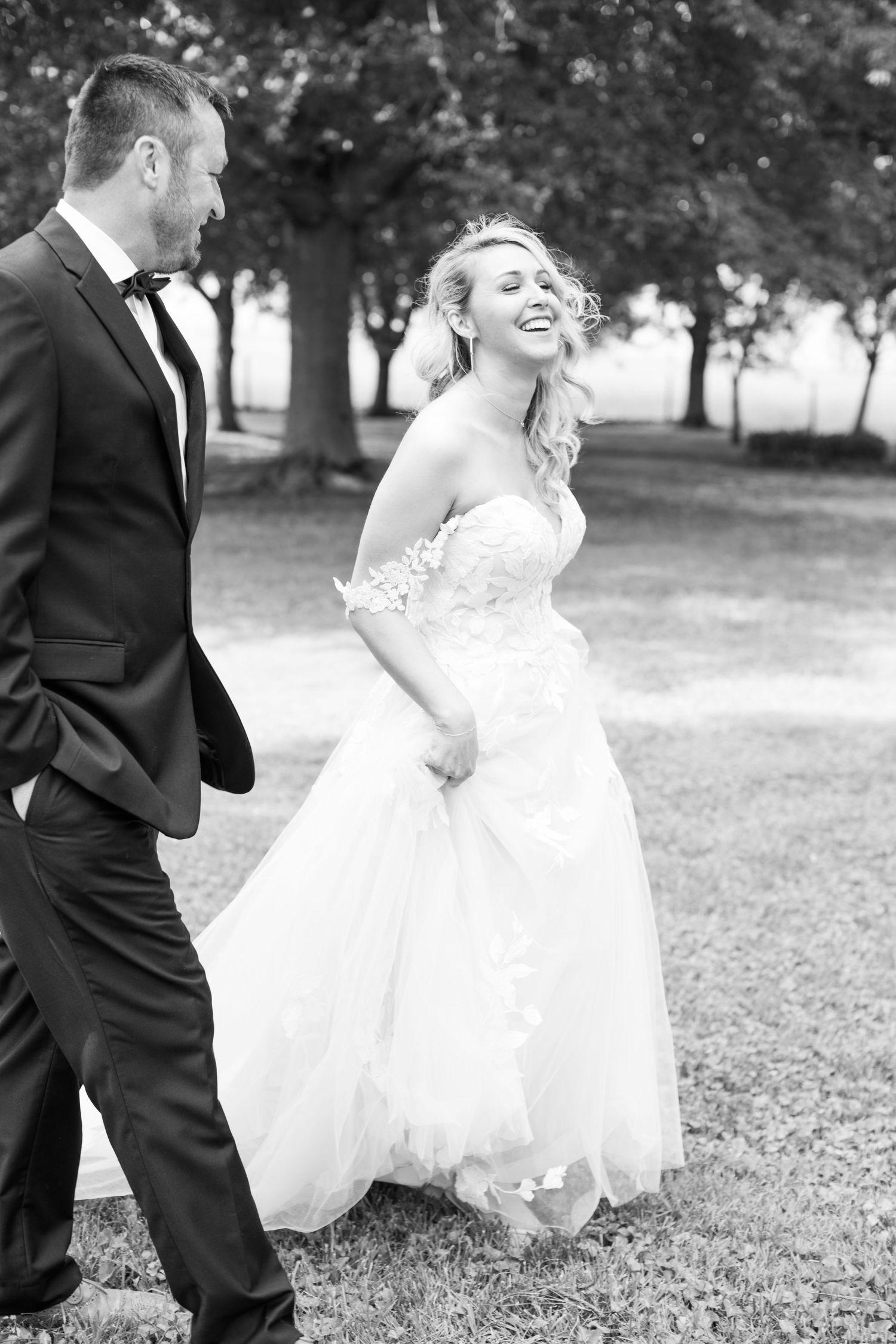 Joyful candid moment between TN newlyweds laughing together outdoors in a black and white photo. Kirstie Whitaker Photography