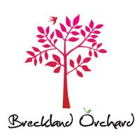 Breckland Orchard logo featuring a stylized pink tree with leaves and a small bird, with elegant script text below.