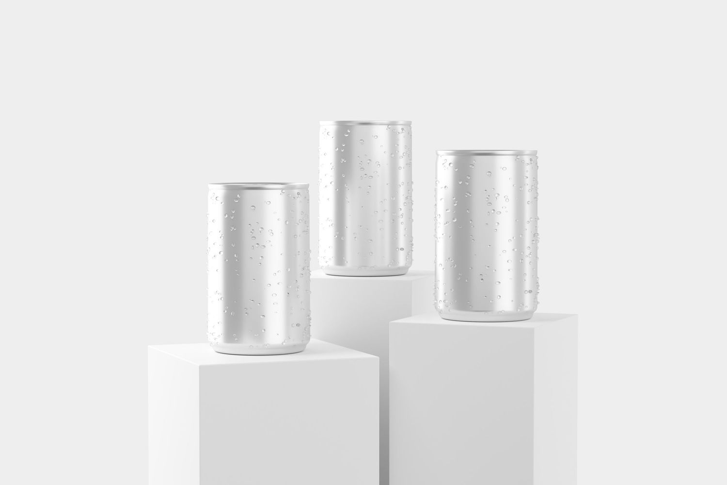 Three silver aluminum cans with water droplets displayed on white pedestals against a light gray background.