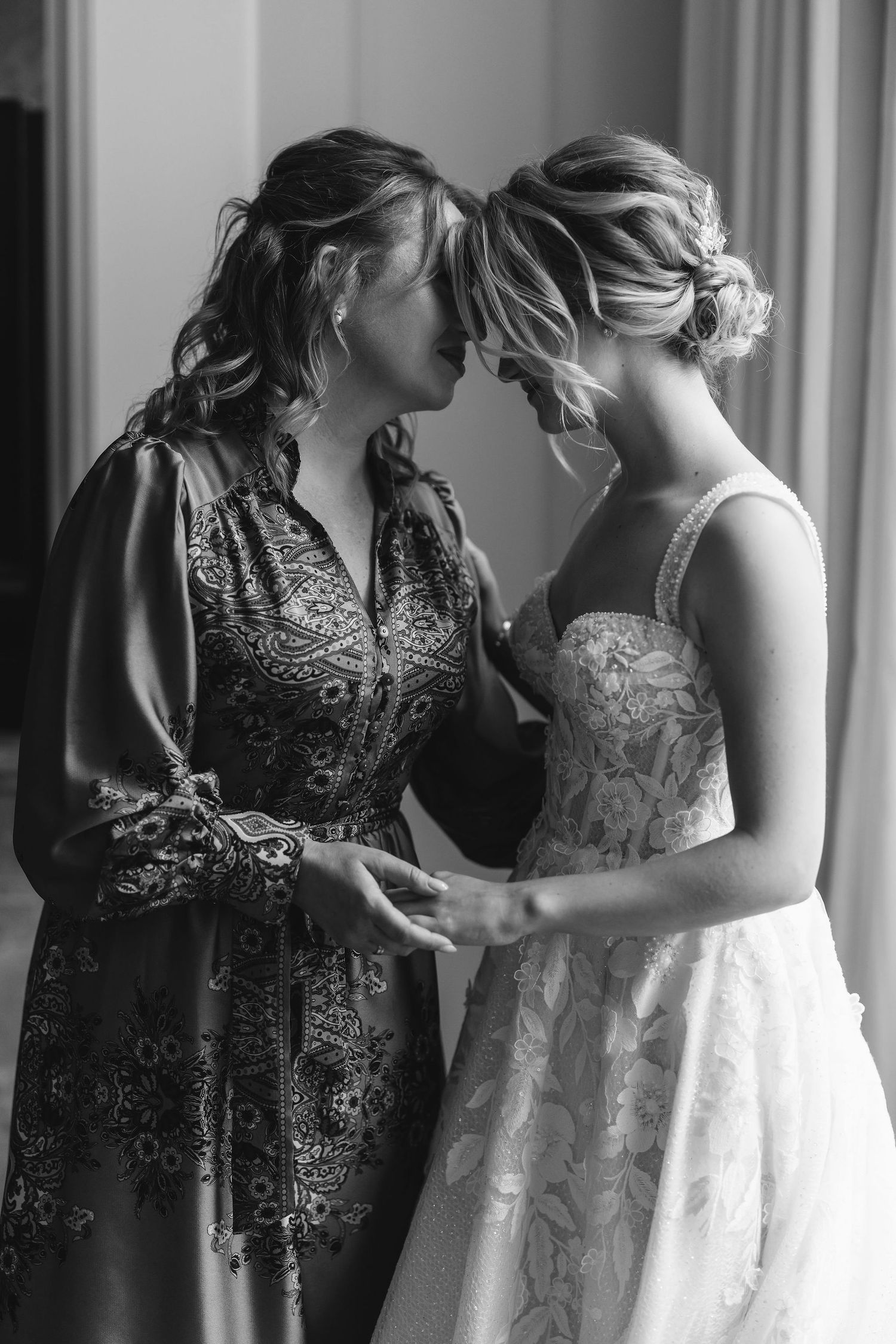 Bridal party in elegant black and white dresses preparing for the wedding ceremony.