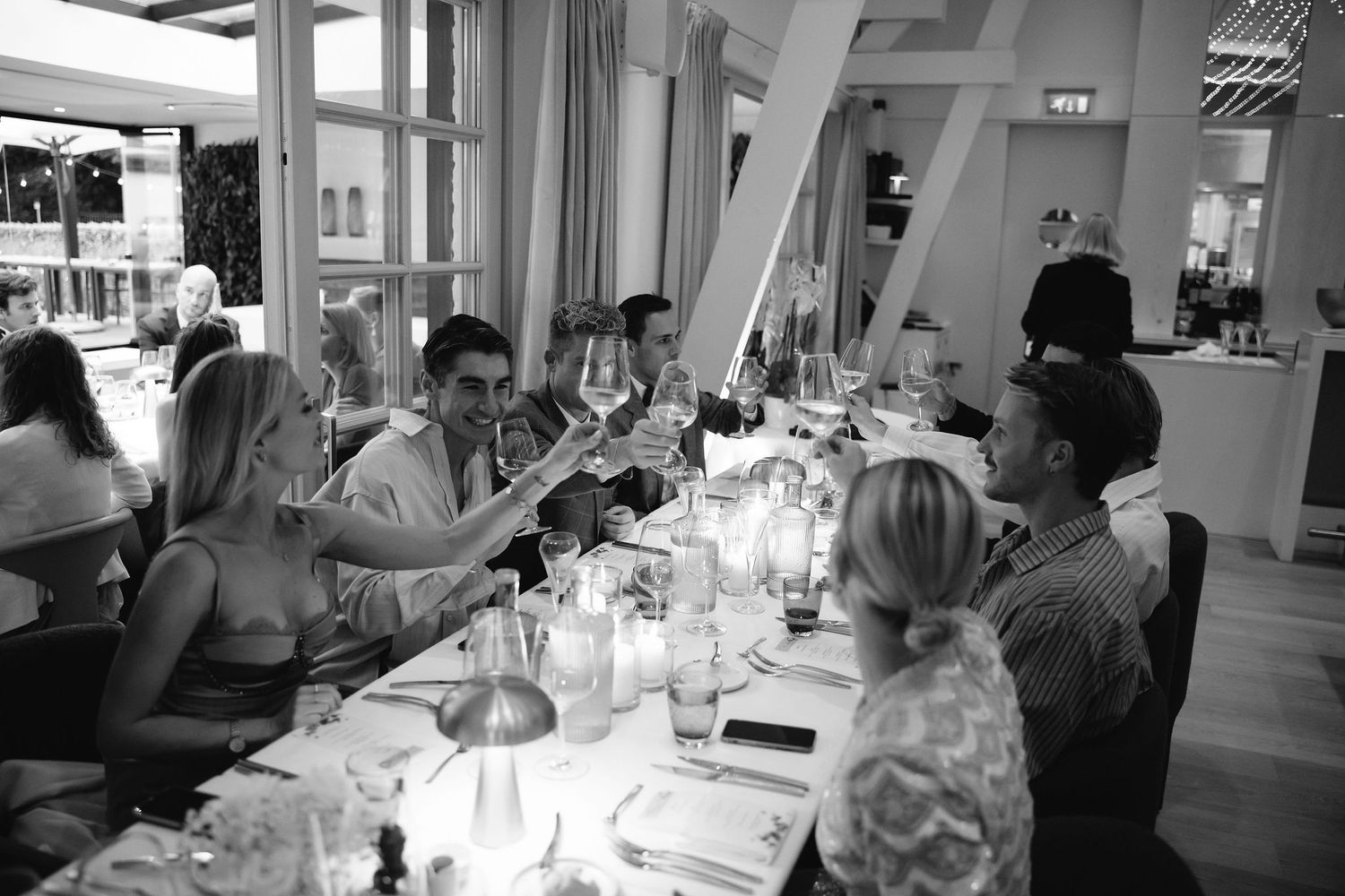 Wedding guests seated at an elegant dining table for a reception dinner.