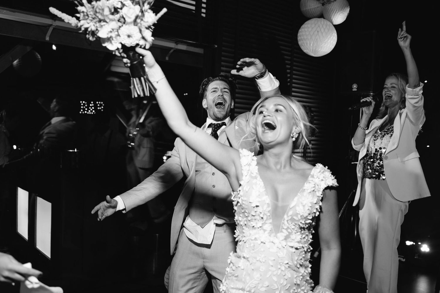 Black and white photo sequence of a dance party celebration with party guests jumping and dancing in joyful revelry.