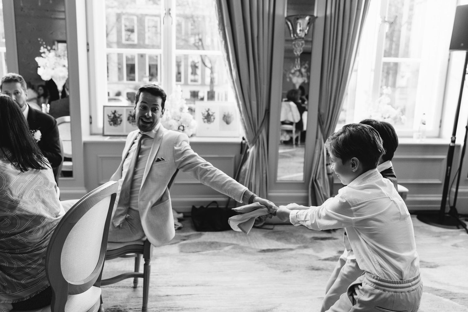Documentary style black and white photos capturing natural moments during a wedding celebration.