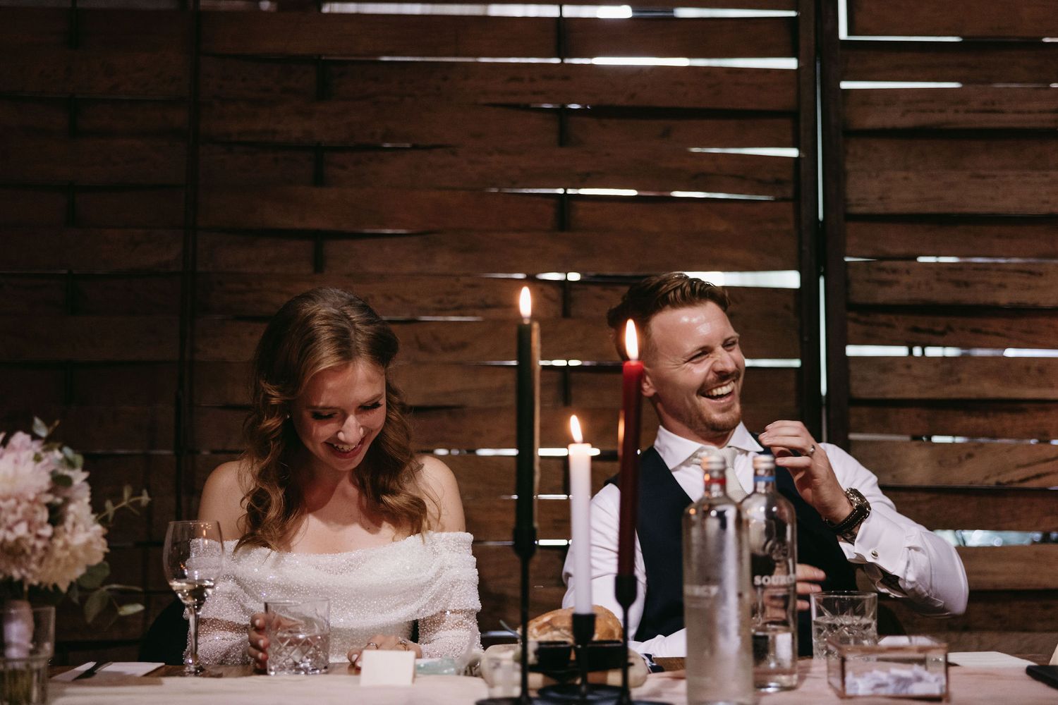An intimate candlelit moment during a wedding reception dinner.