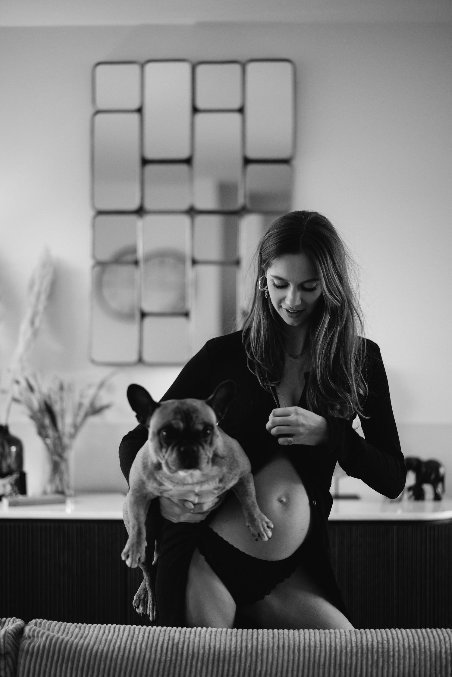 Black and white composition showing playful moments with cat on furniture.