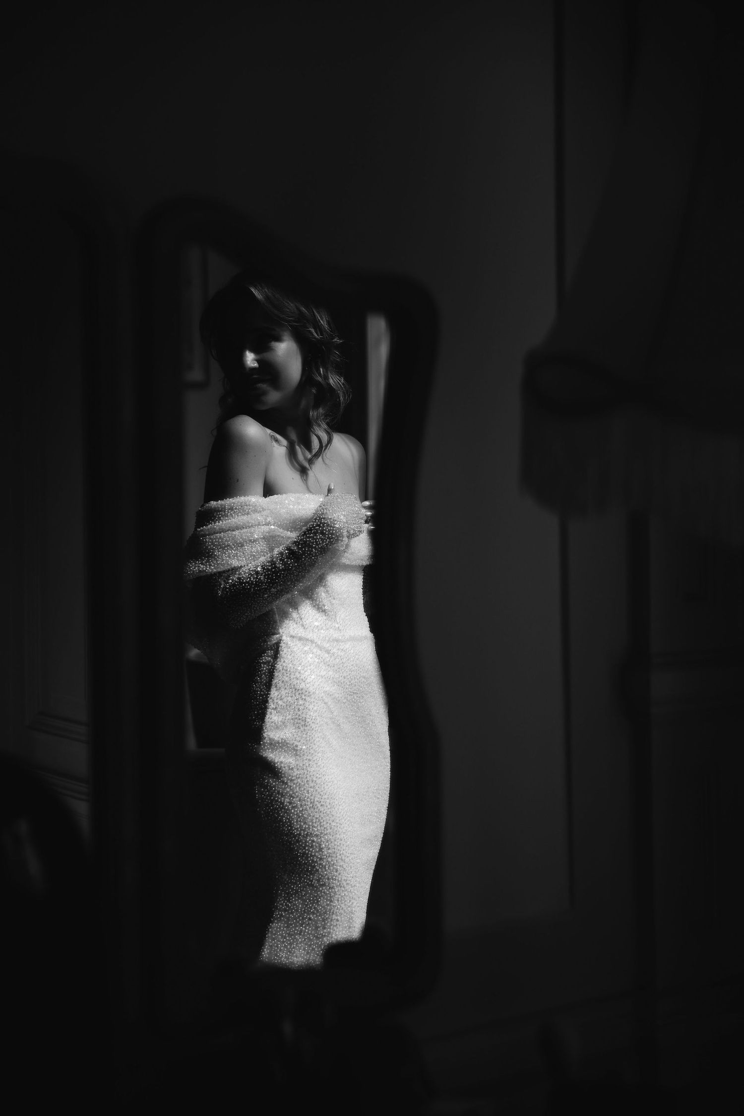 Dramatic black and white portrait of bridal gown with feather details.