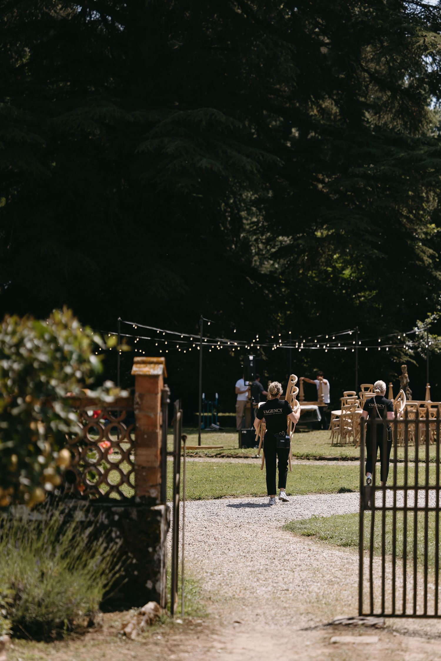 Garden entrance with open iron gates leading to an outdoor event space.