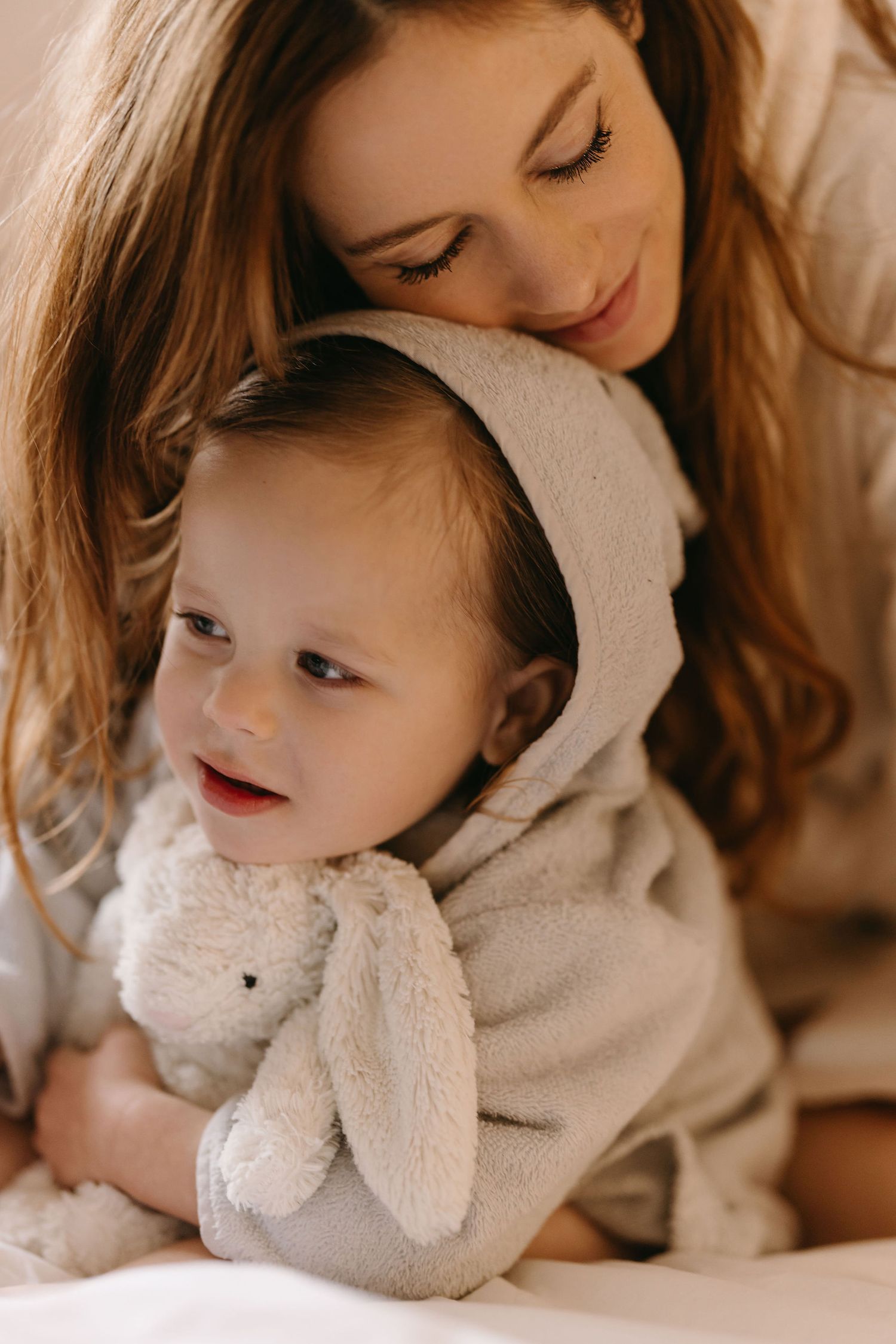 Soft and cozy moments with a plush bunny toy in warm lighting.