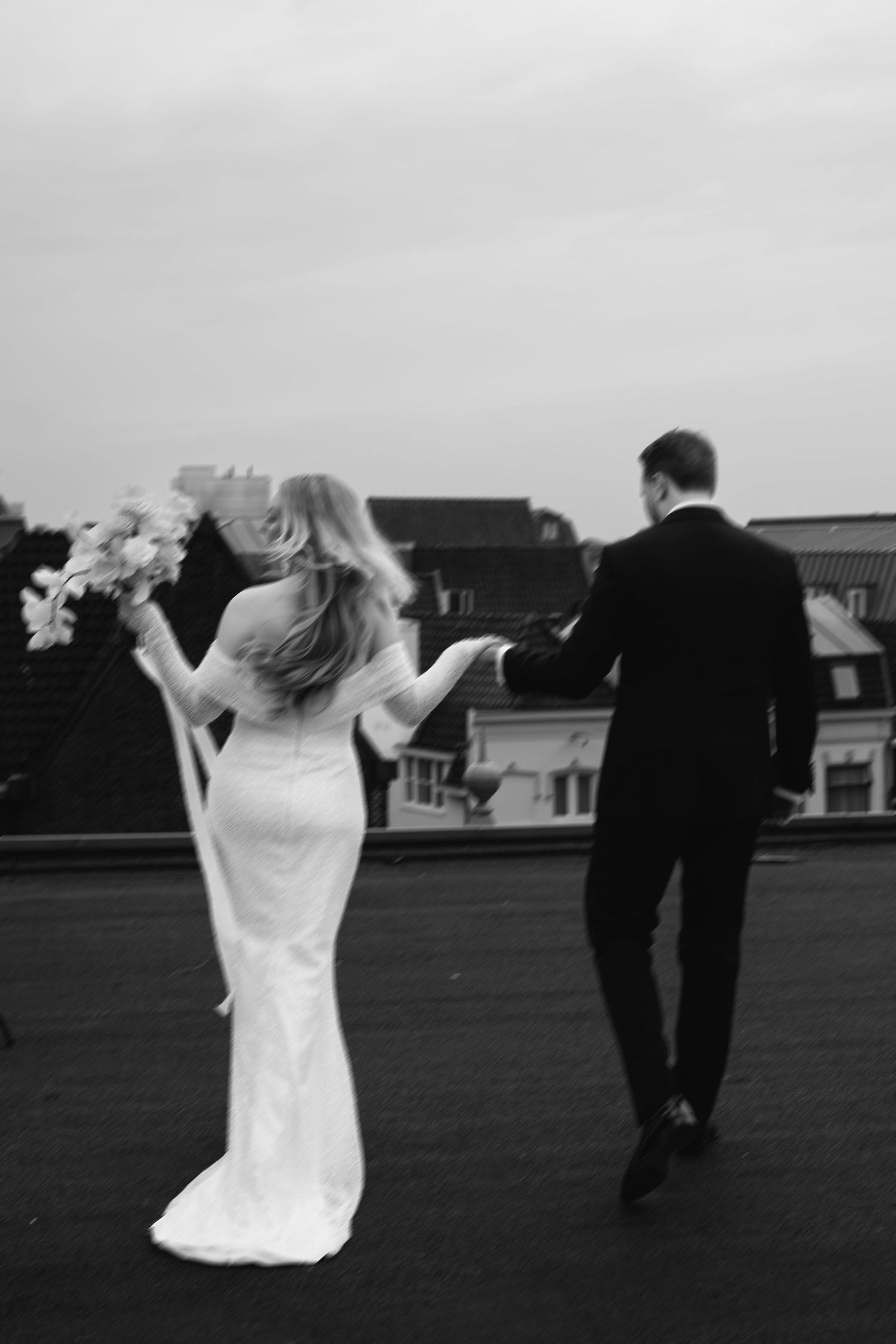 Black and white photo sequence showing a person in a white dress and person in black suit walking apart on a grassy field.