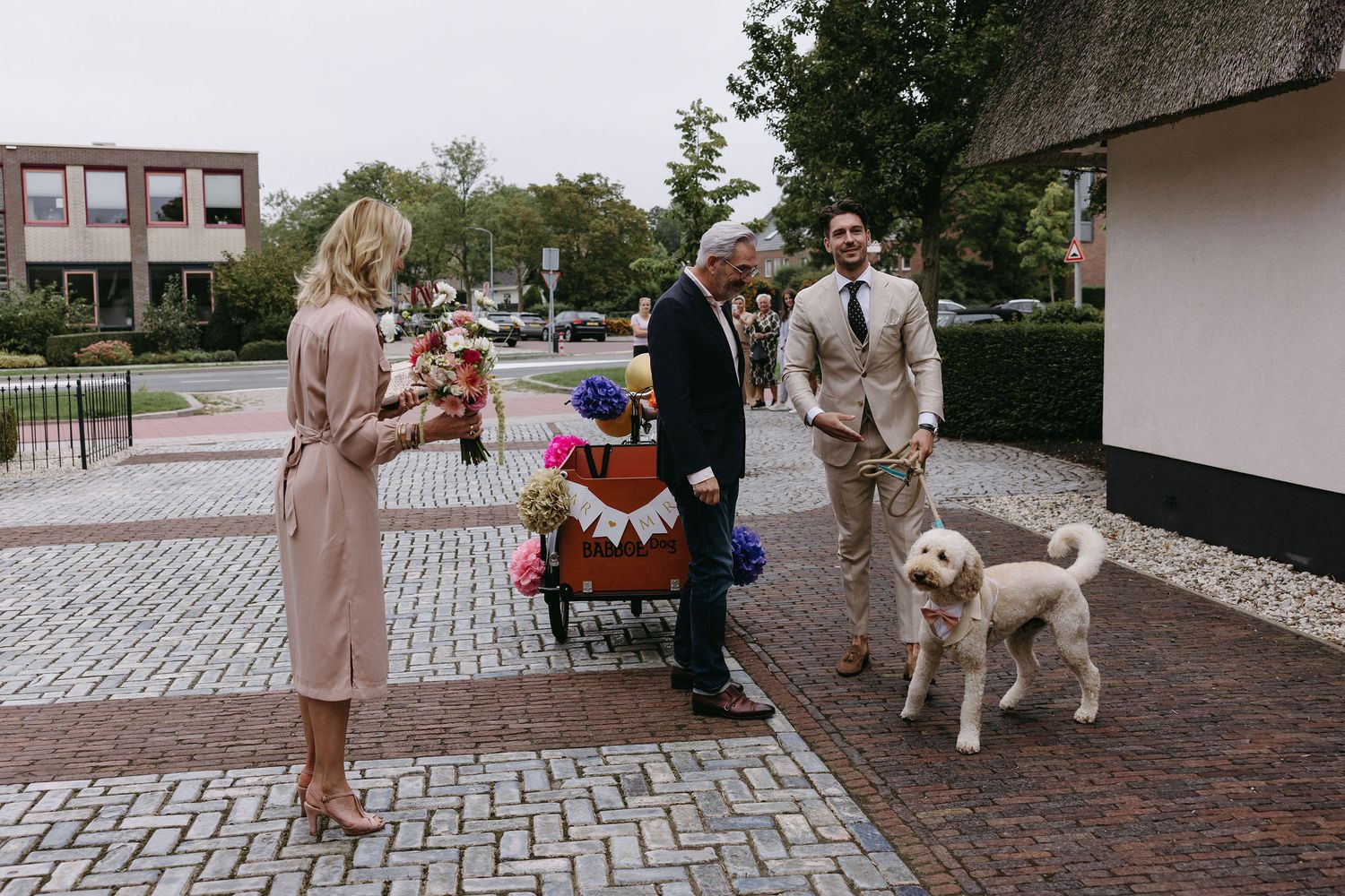 A series of candid moments outside a wedding venue with beige and neutral-toned outfits.