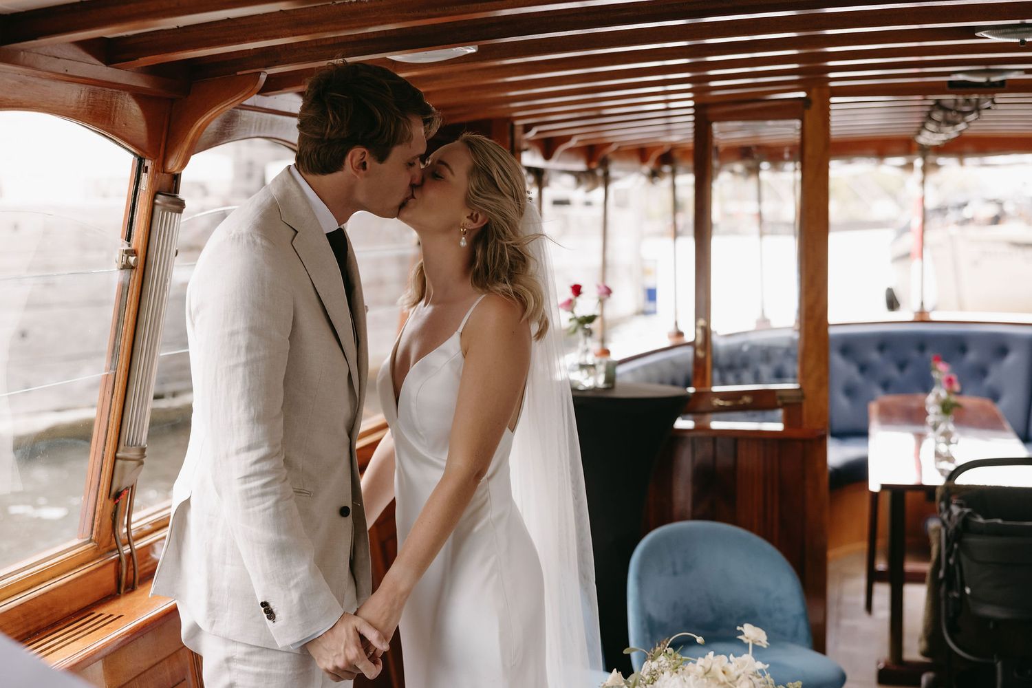 Tender moment captured inside a classic wooden boat interior.