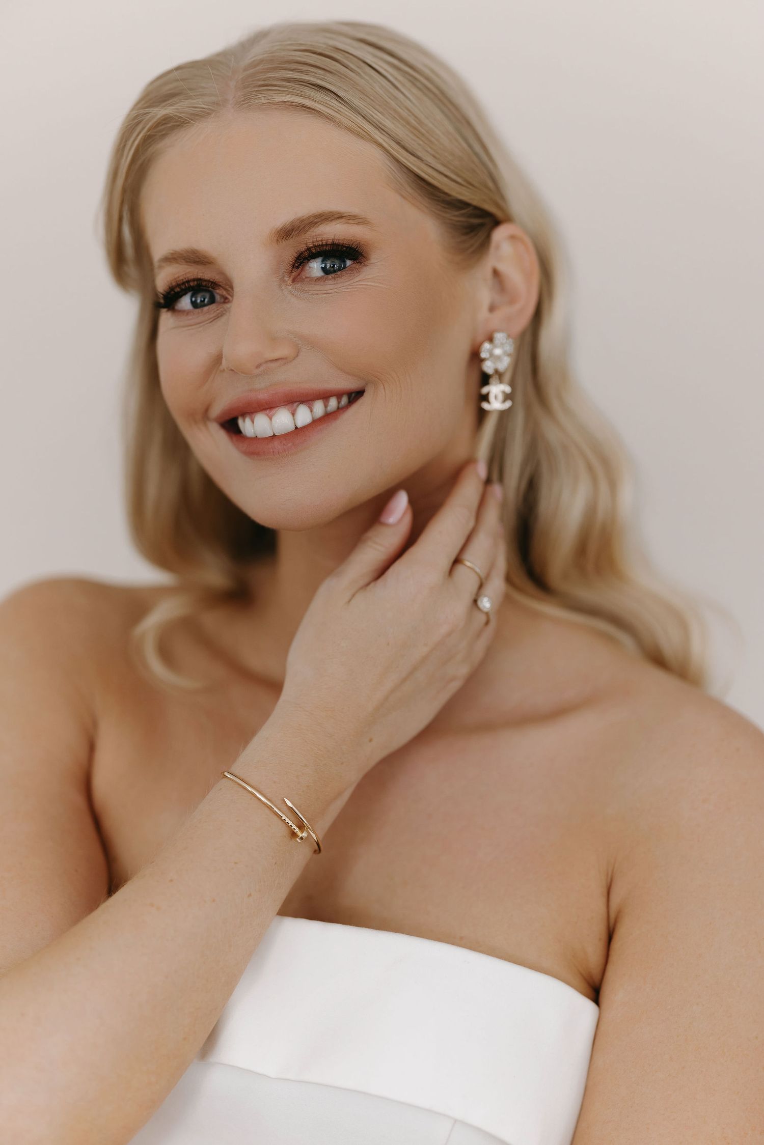 Elegant portrait showcasing delicate jewelry and classic bridal styling.