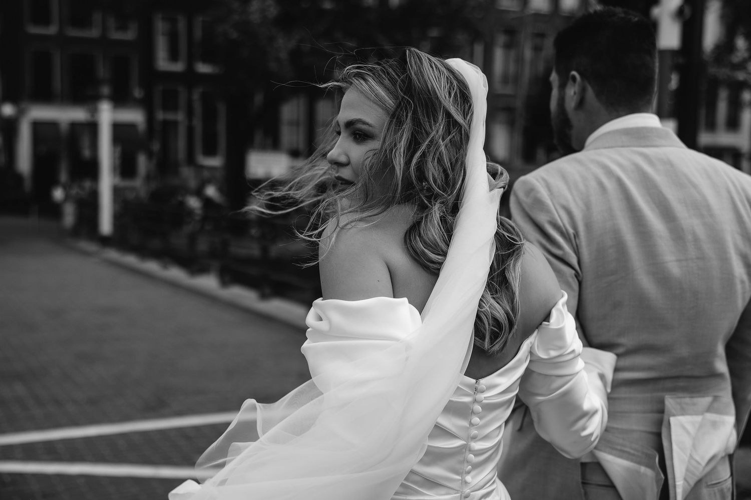 Candid outdoor wedding moments in natural light captured in black and white.