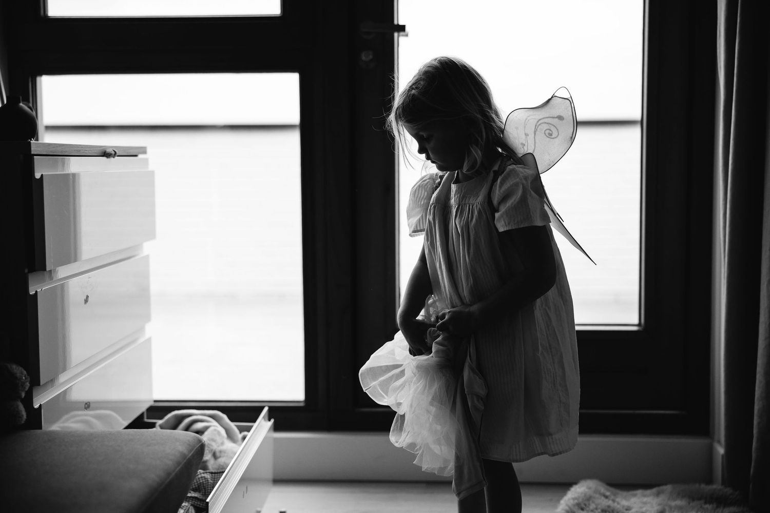 A series of intimate black and white photos captured near a sunlit window.