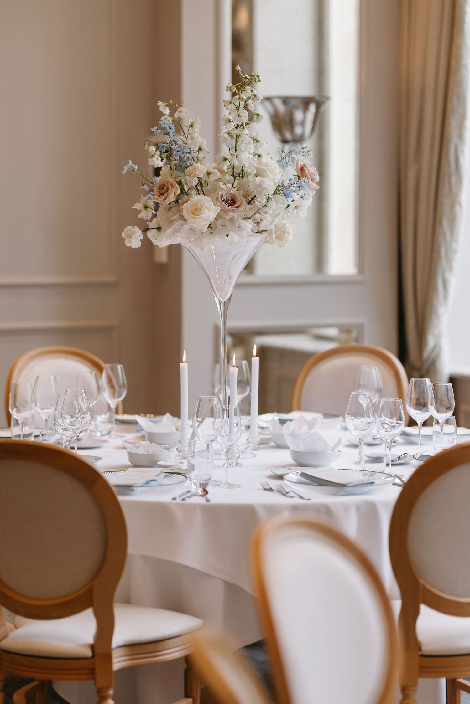 Elegant wedding table settings with delicate floral centerpieces and crystal glassware.