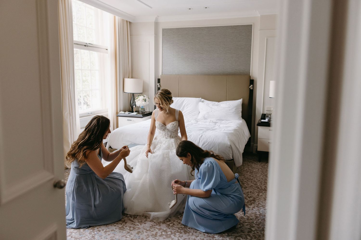 Getting ready moments before the wedding in an elegant modern room with gray and white tones.