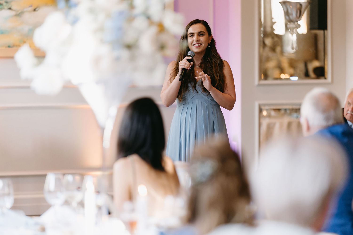 A person gives an emotional speech at an elegant wedding reception.