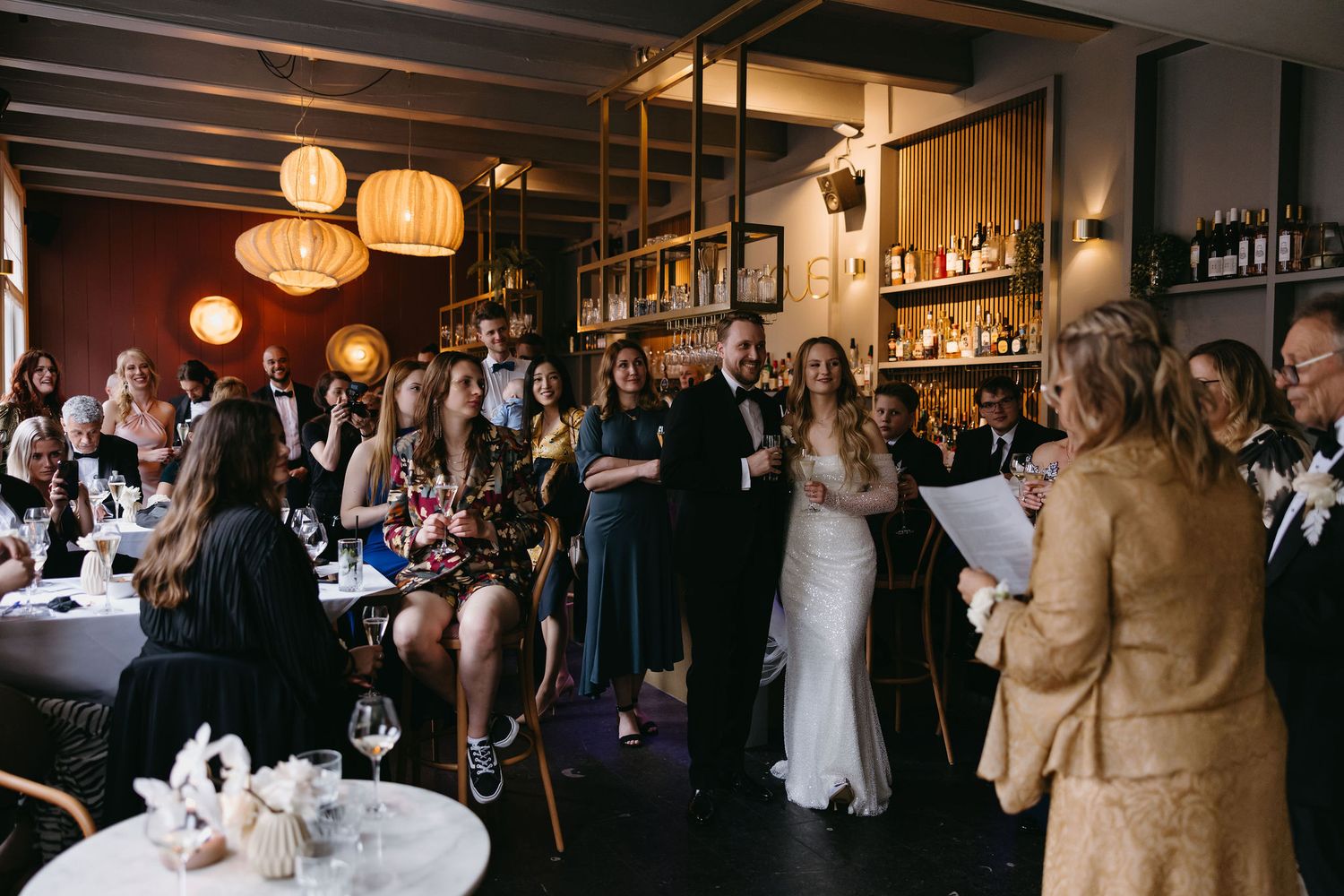 Festive wedding reception venue with paper lanterns and warm lighting.