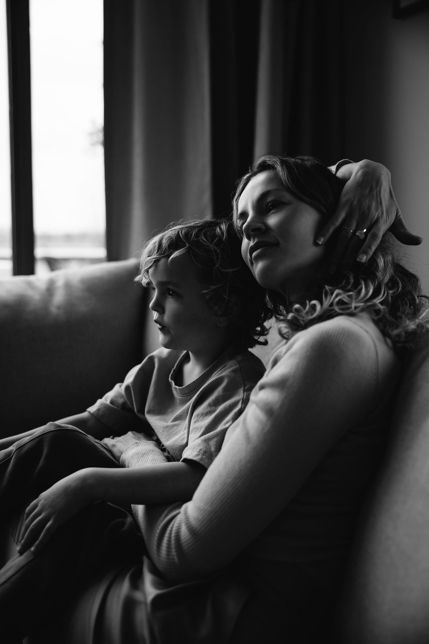 Dramatic black and white profile shots showing relaxed poses in moody lighting.