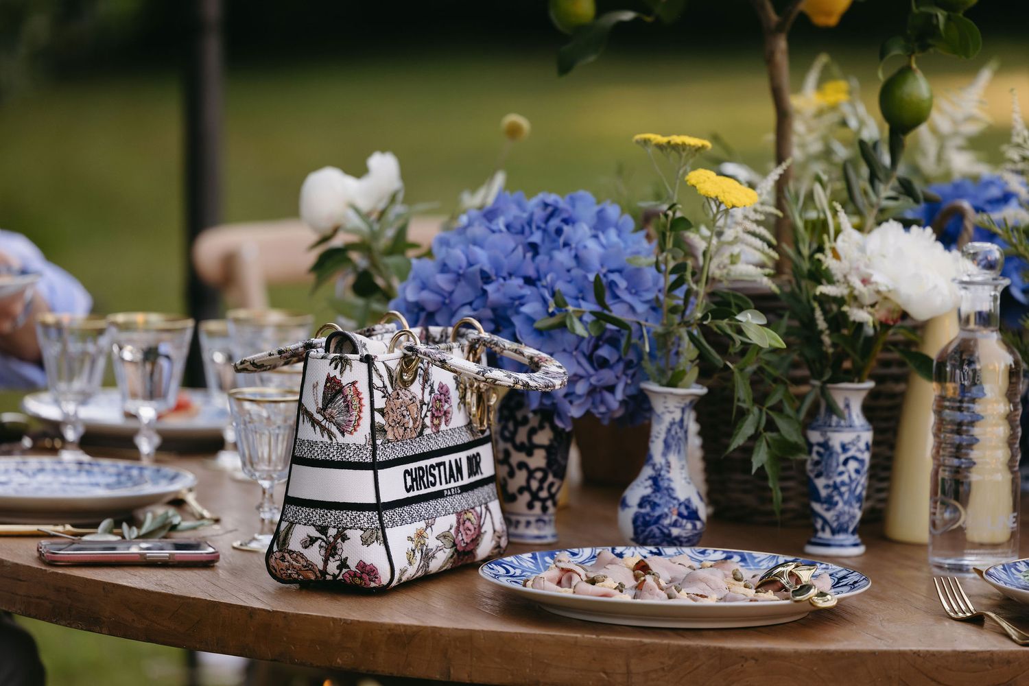 Wedding table decor with blue hydrangeas and blue-and-white chinoiserie accents.
