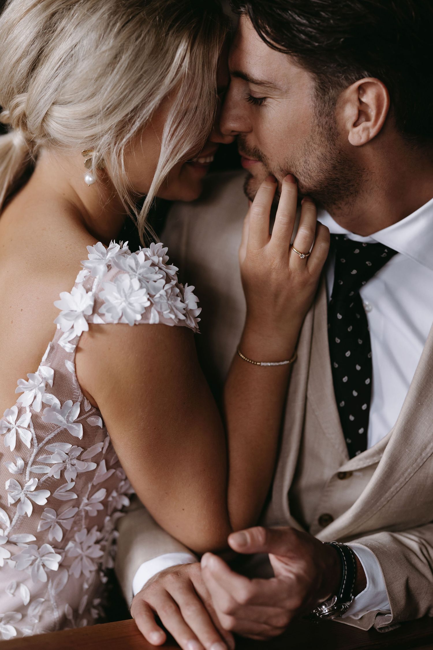 Intimate romantic wedding portraits featuring delicate floral lace details and tender moments.