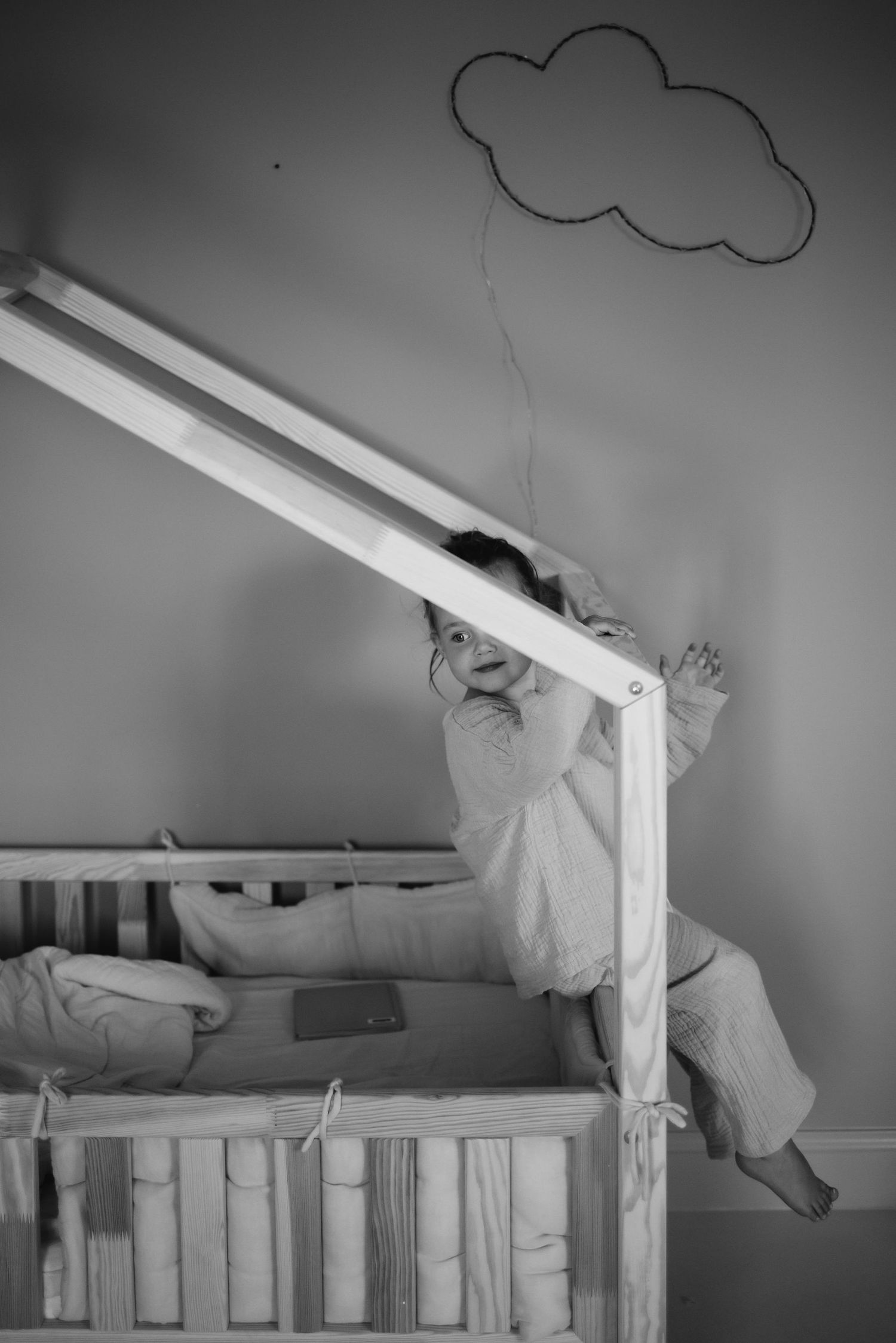 Black and white sequence showing a nursery with hand-drawn clouds and crib details.