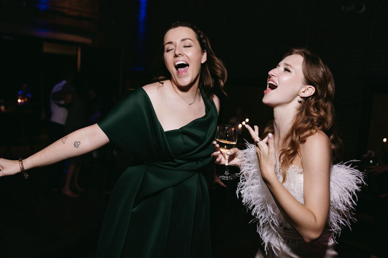 Guests enjoying themselves on a dimly lit dance floor at a celebration.
