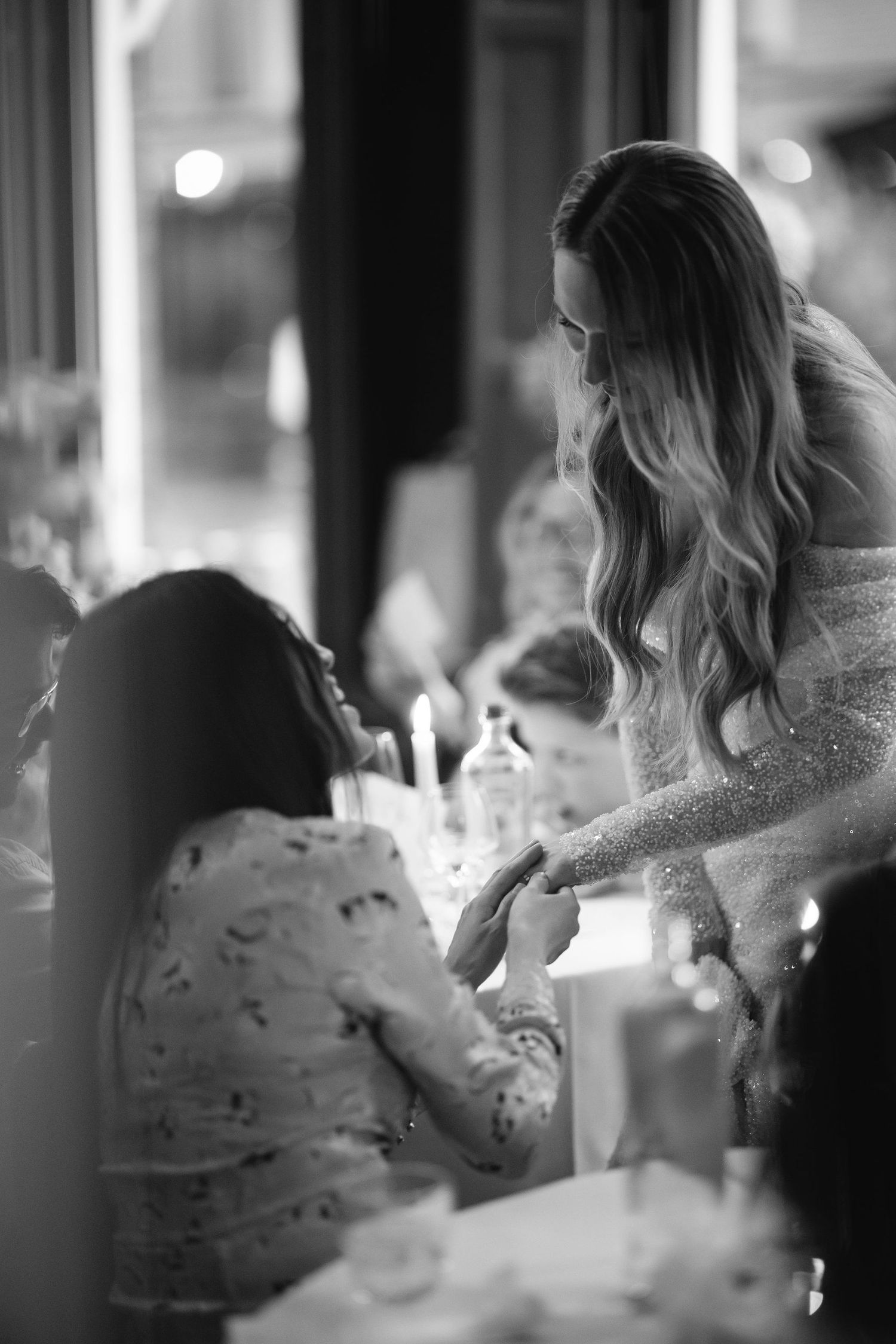 Candlelit wedding reception moment captured in intimate black and white photography.