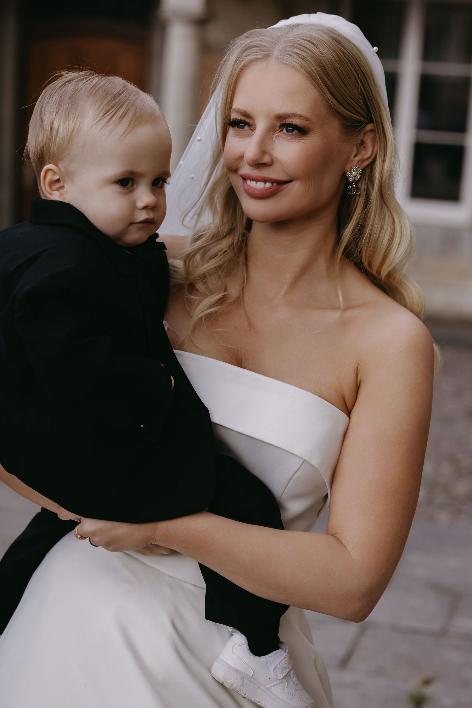 A tender moment captured in formal attire with a small child.