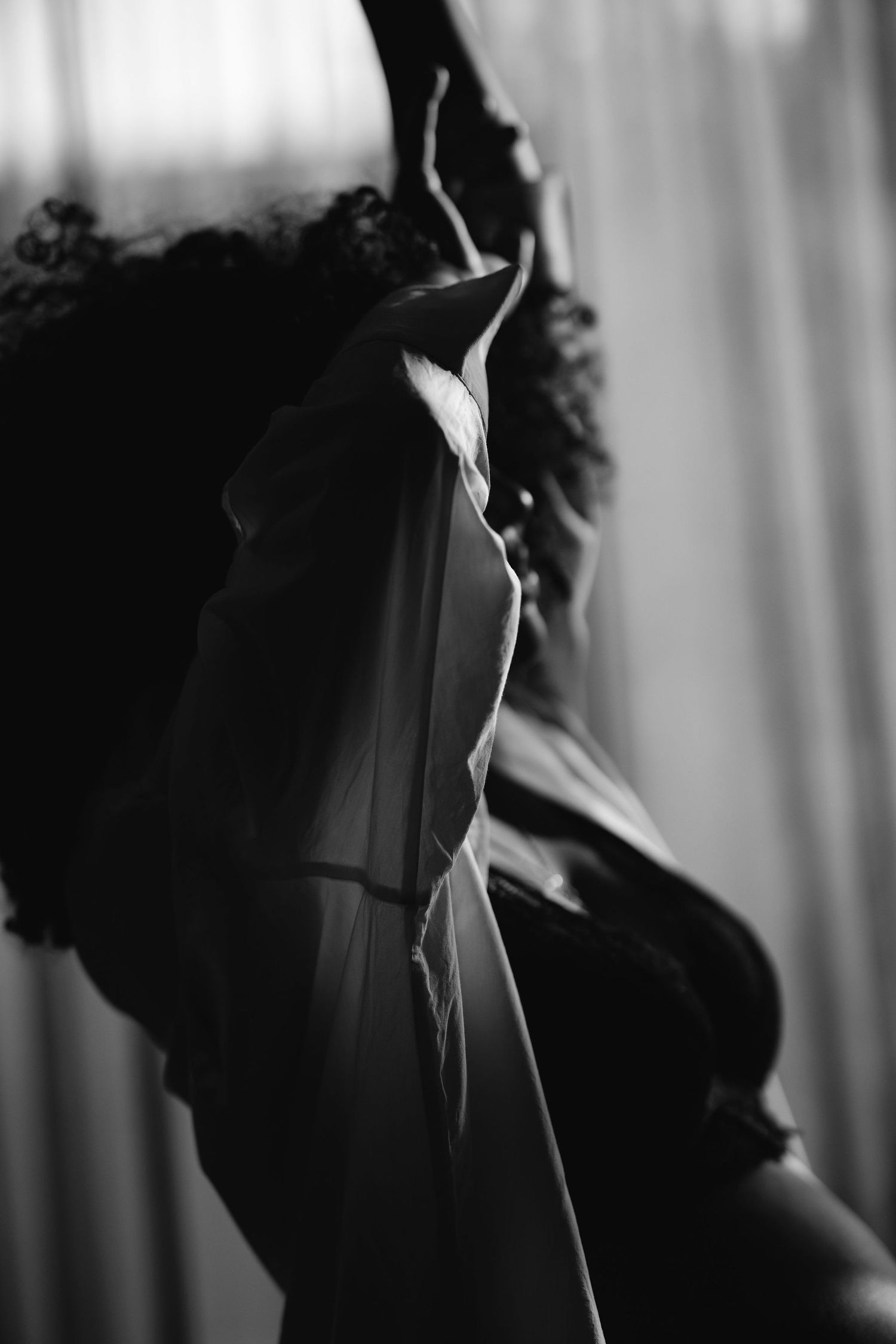Black and white portrait showing dramatic shadows and curves.