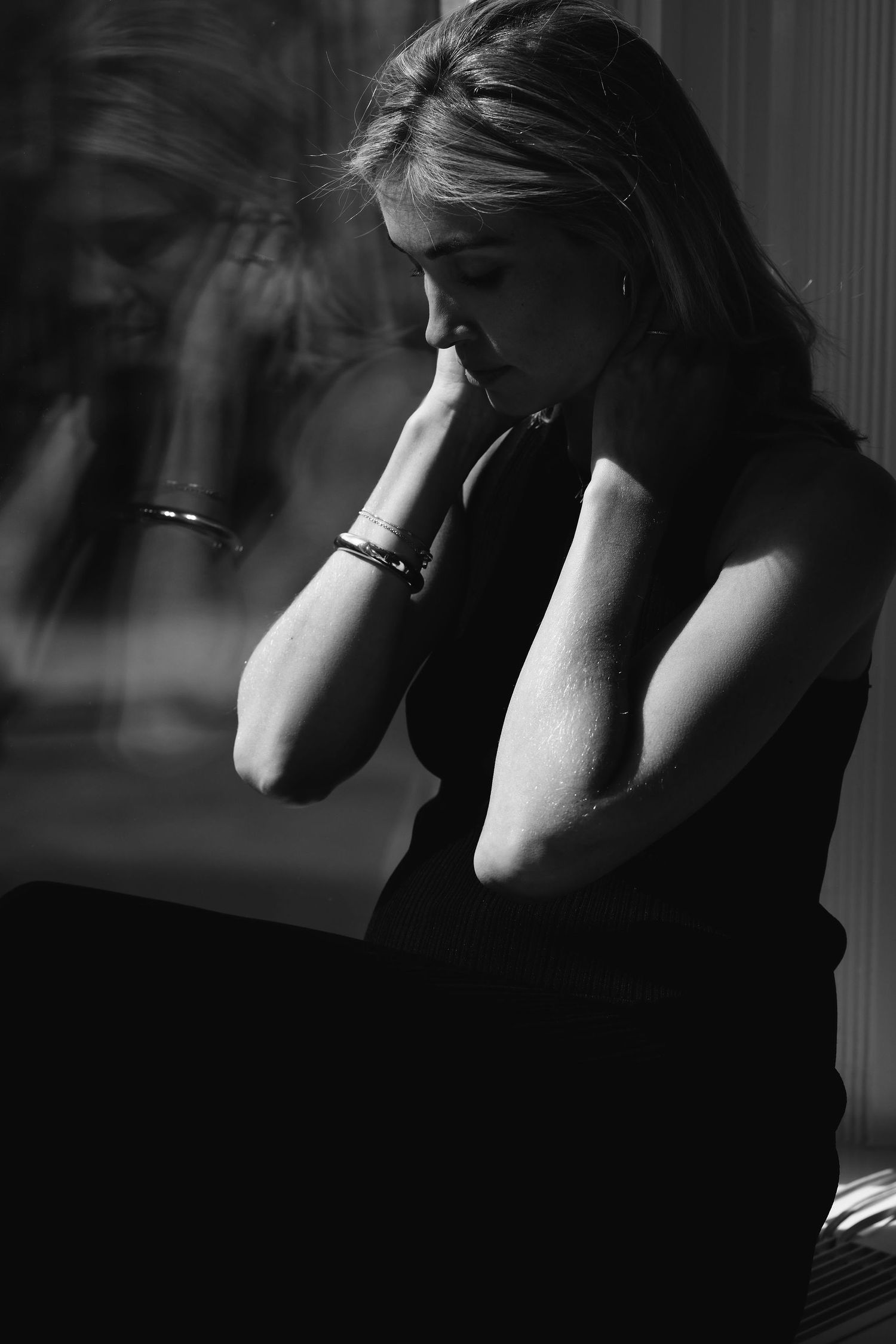 Dramatic black and white portrait series showing silhouettes and shadows against natural light.