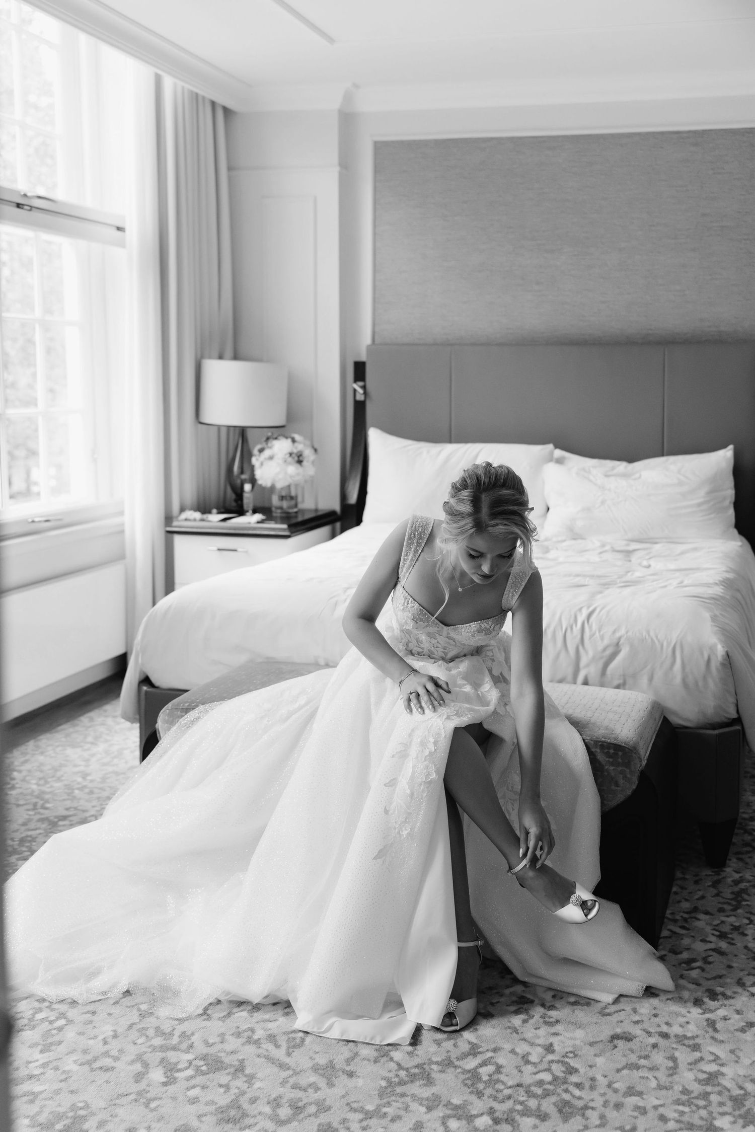 Black and white photo series showing a voluminous wedding dress against a carpeted hotel room floor.