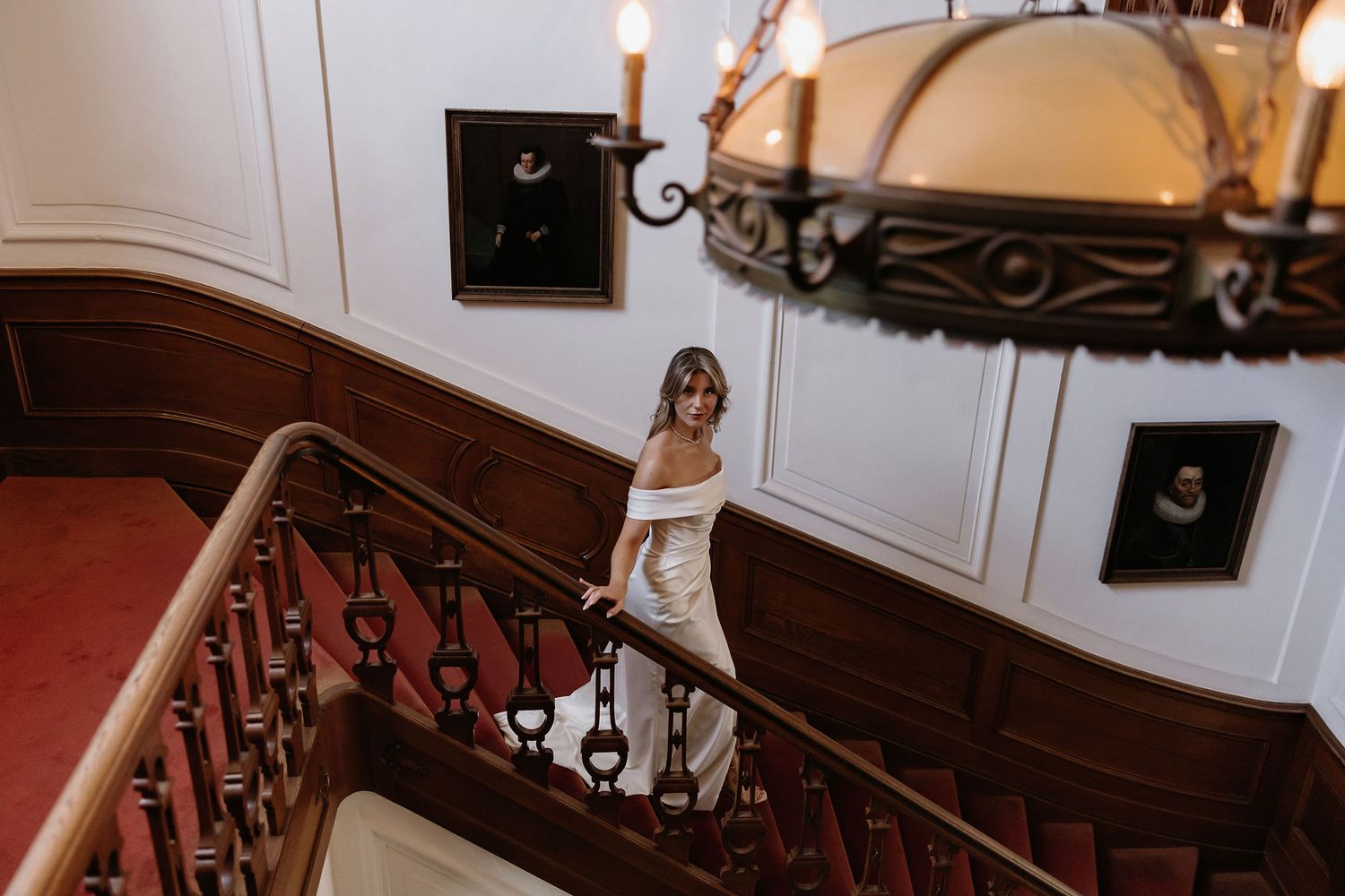 A detailed view of an ornate carved wooden staircase railing in a traditional residential interior.