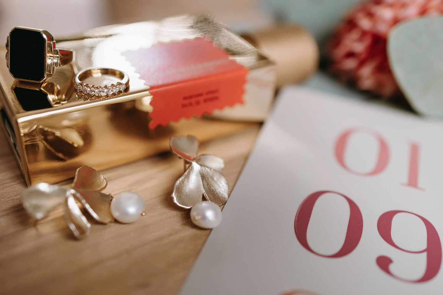 Wedding detail shot of table numbers and decorative elements in soft focus.