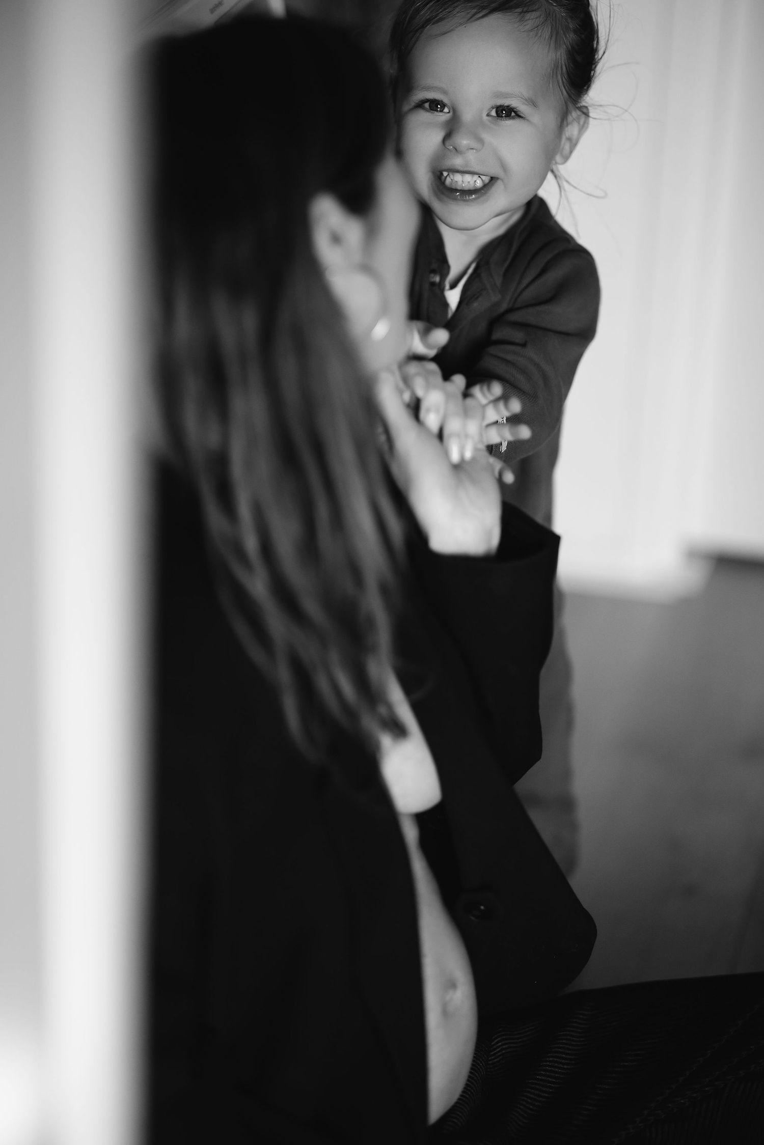 Black and white candid photo showing a playful moment.