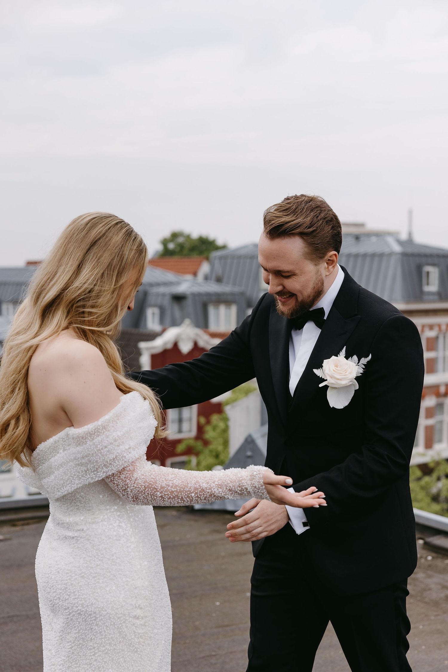 Candid rooftop moment between newlyweds during their wedding portraits.