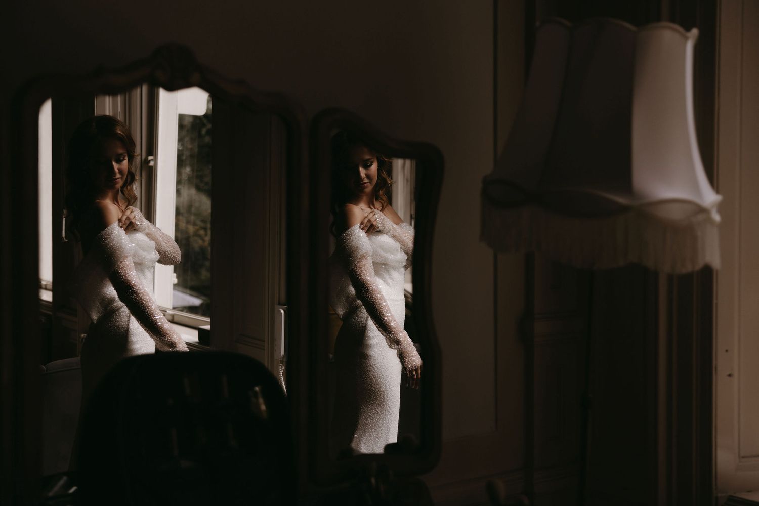 Wedding celebration in a dark, intimate indoor venue with atmospheric lighting.