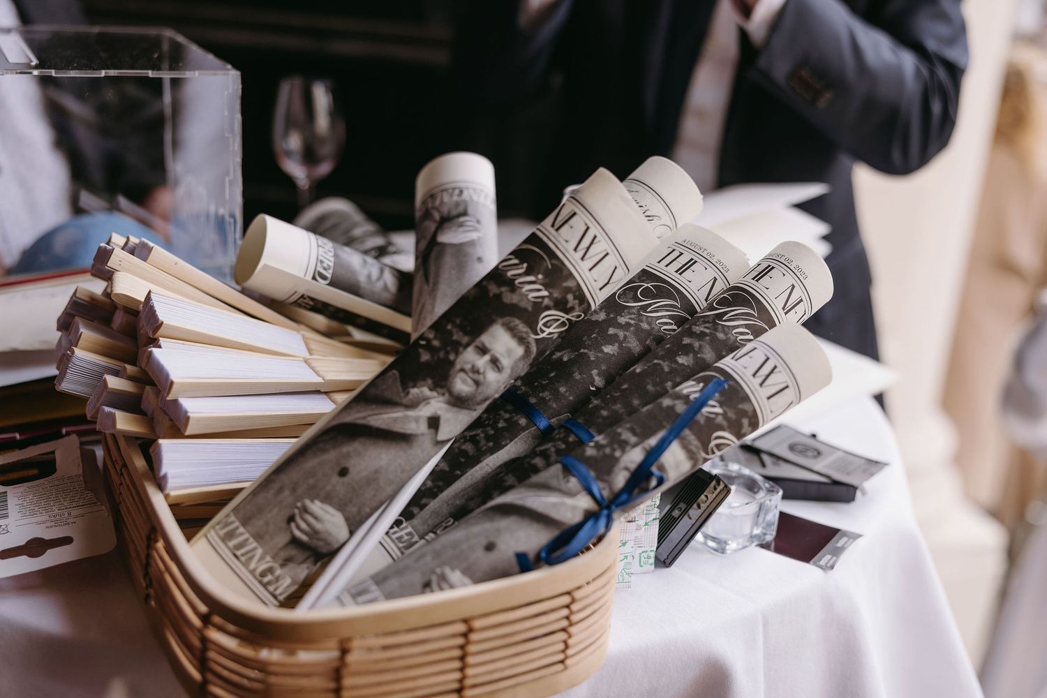 Close-up details of vintage newspapers and documents in woven basket.