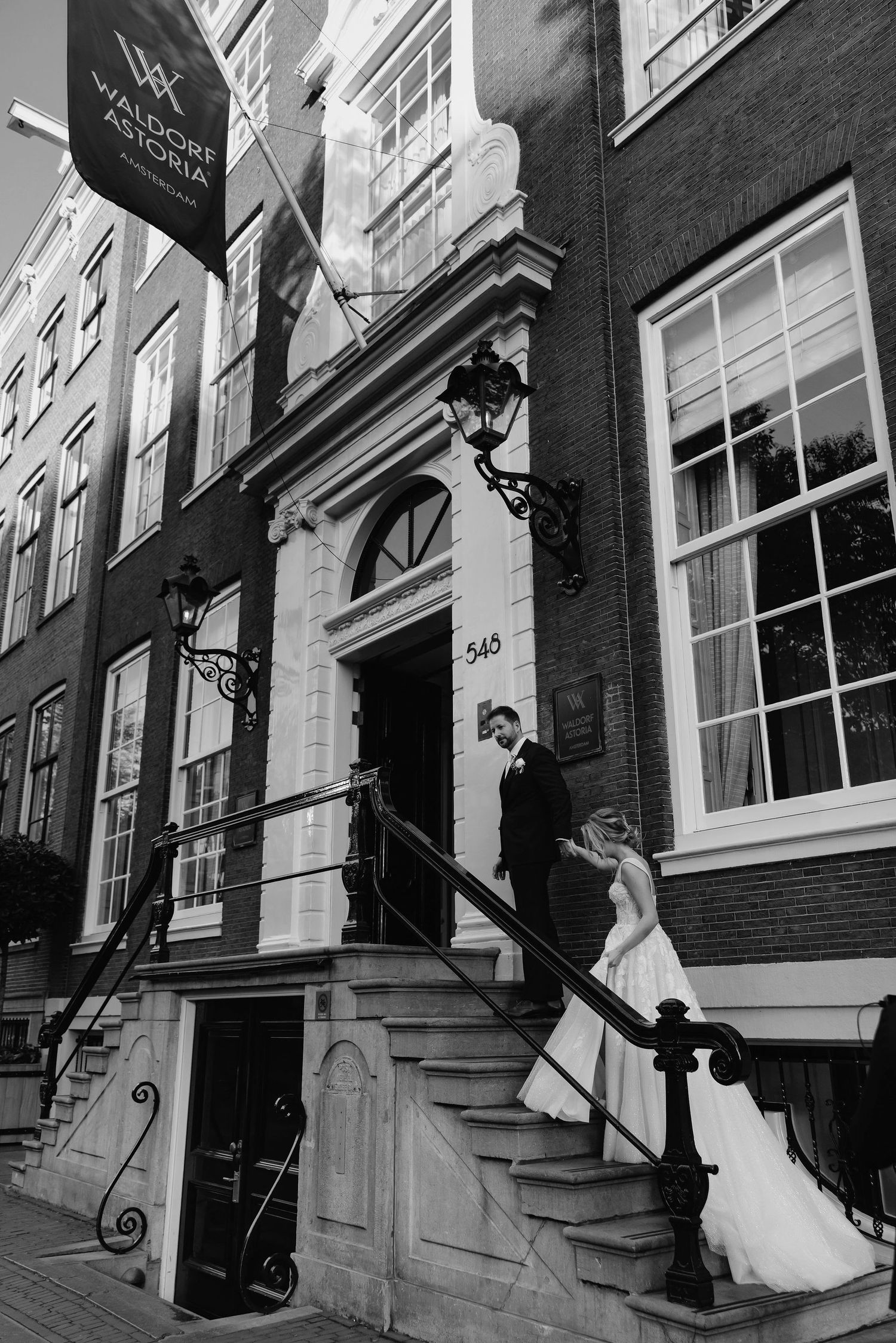 A series of black and white photos showing a couple ascending historic brick building steps.
